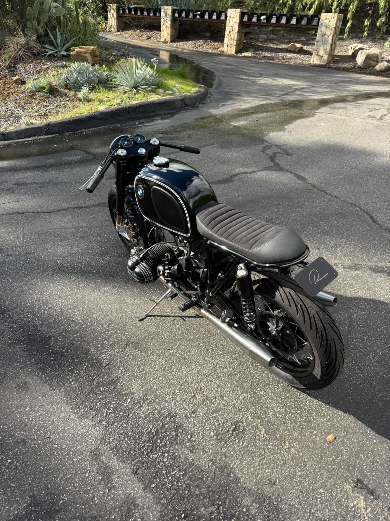 Rear three-quarter view of the BMW airhead cafe racer showing the MAD Exhausts twin cone mufflers
