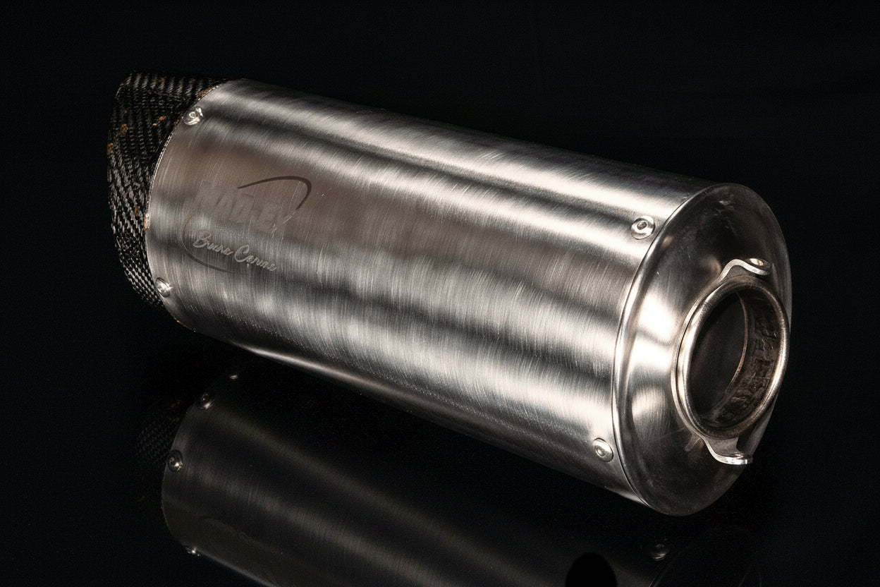 MAD-EX R1 race muffler viewed from the outlet end showing the stainless body and open pipe, studio photo on black