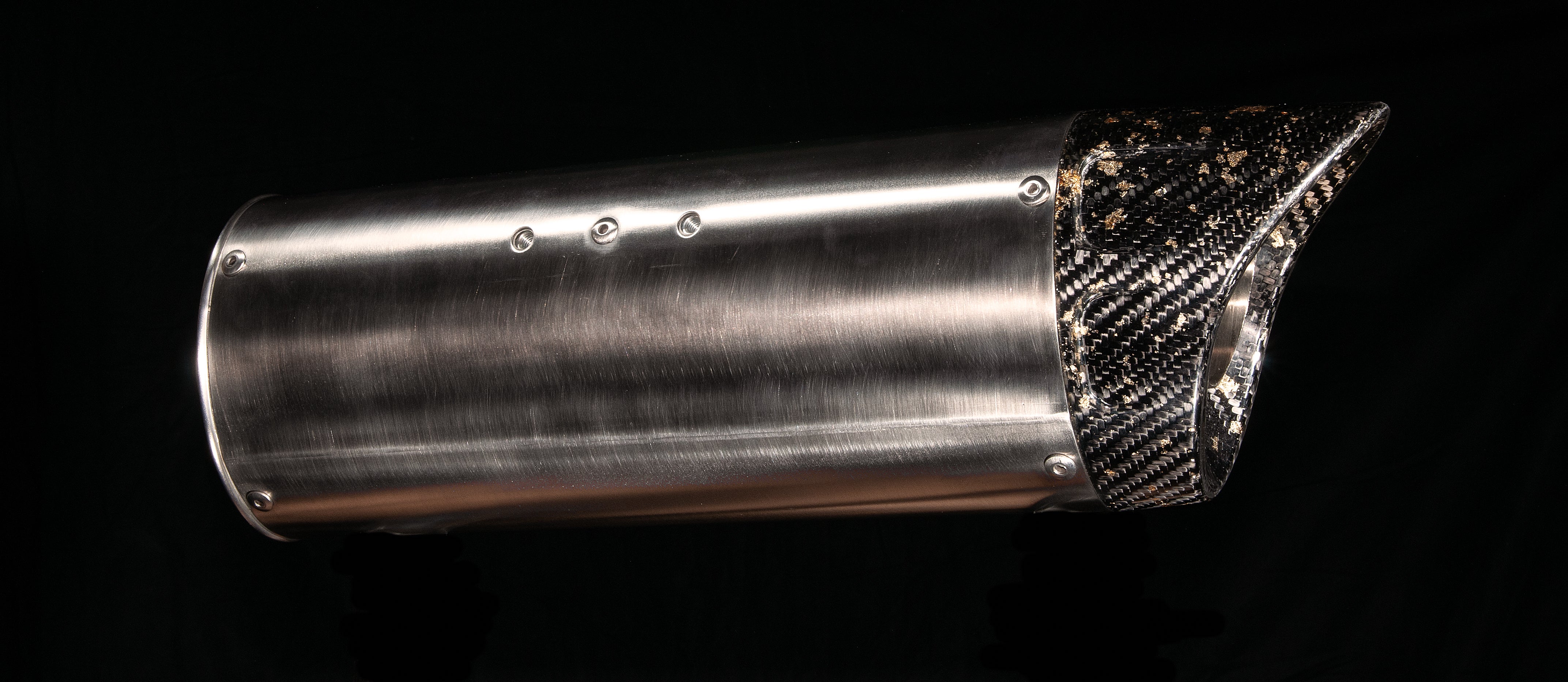 Full side profile of the MAD-EX R1 race muffler with brushed stainless body and angled carbon end cap, studio photo on black
