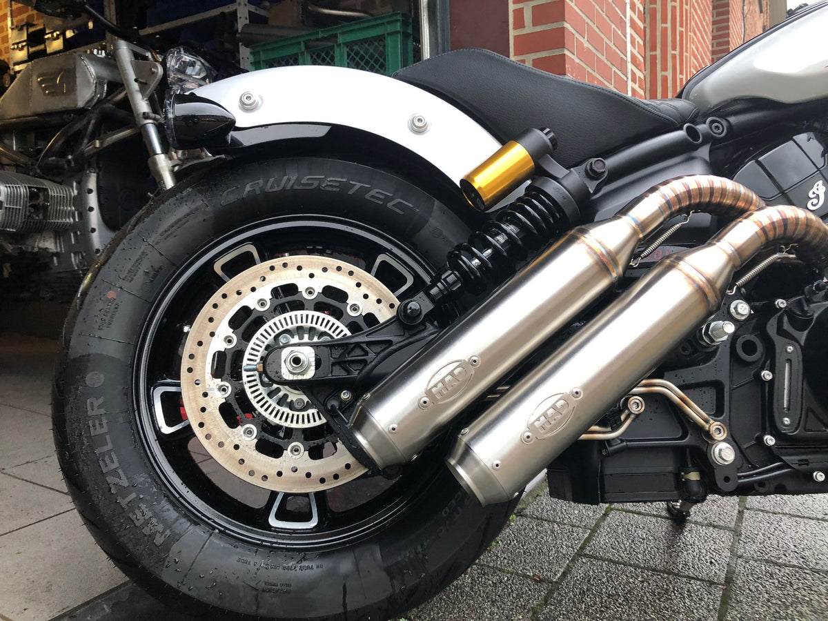 Twin down-swept MAD Exhausts silencers mounted at the rear wheel of the Indian Scout 1250, side view