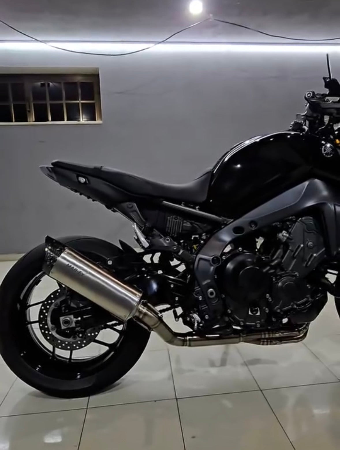 Black Yamaha MT-09 fitted with the MAD Exhausts stainless steel performance system, full side view