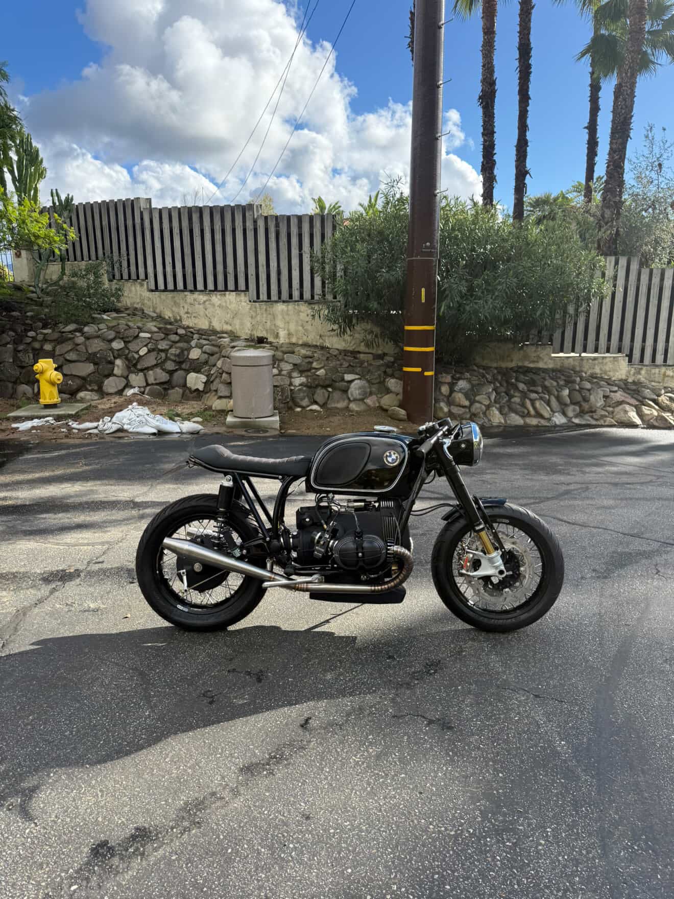 Right-side view of the BMW airhead cafe racer showing the MAD Exhausts header and cone muffler, street setting