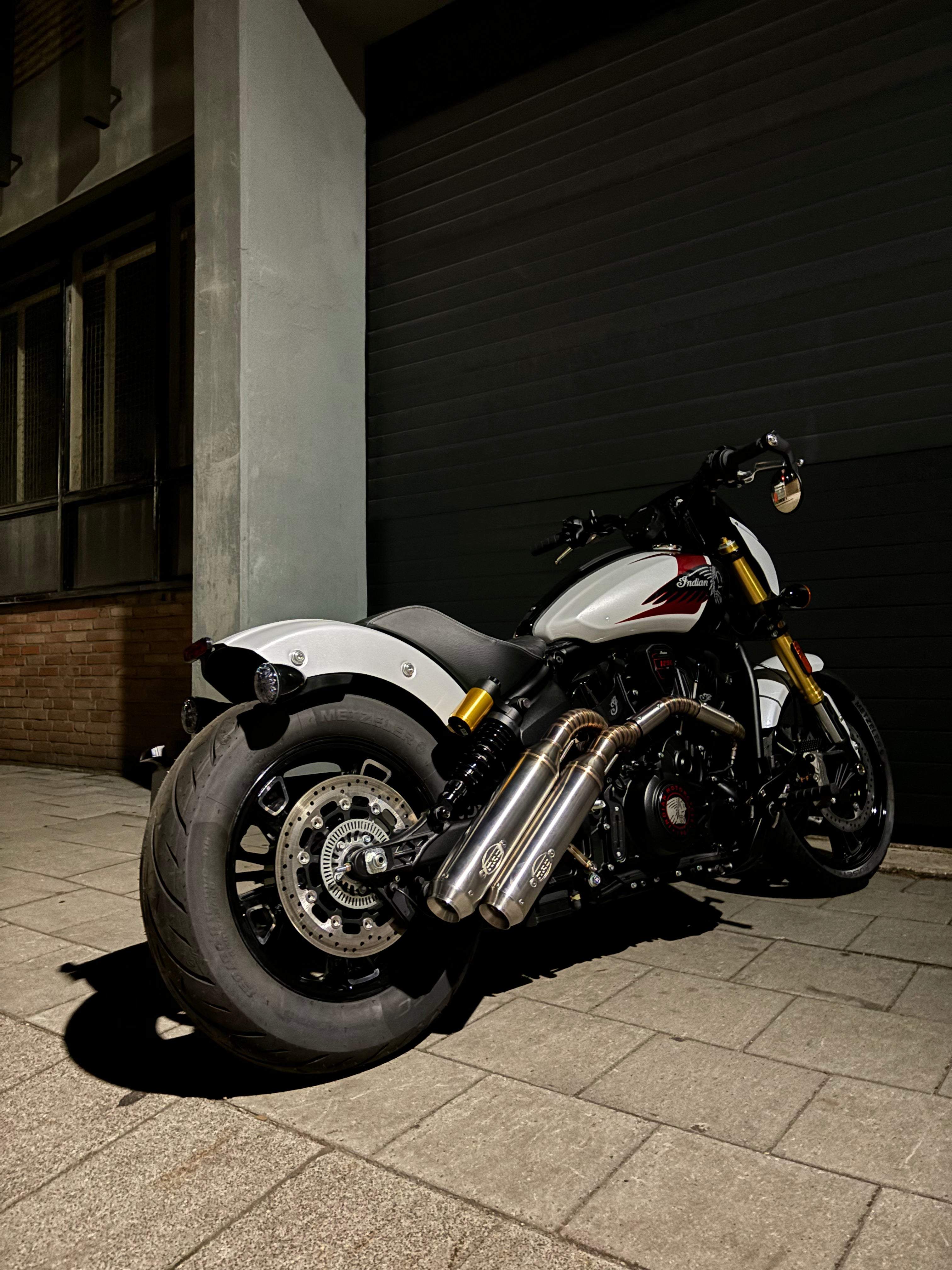 Indian Scout 1250 rear three-quarter view showing the twin MAD Exhausts down-swept silencers