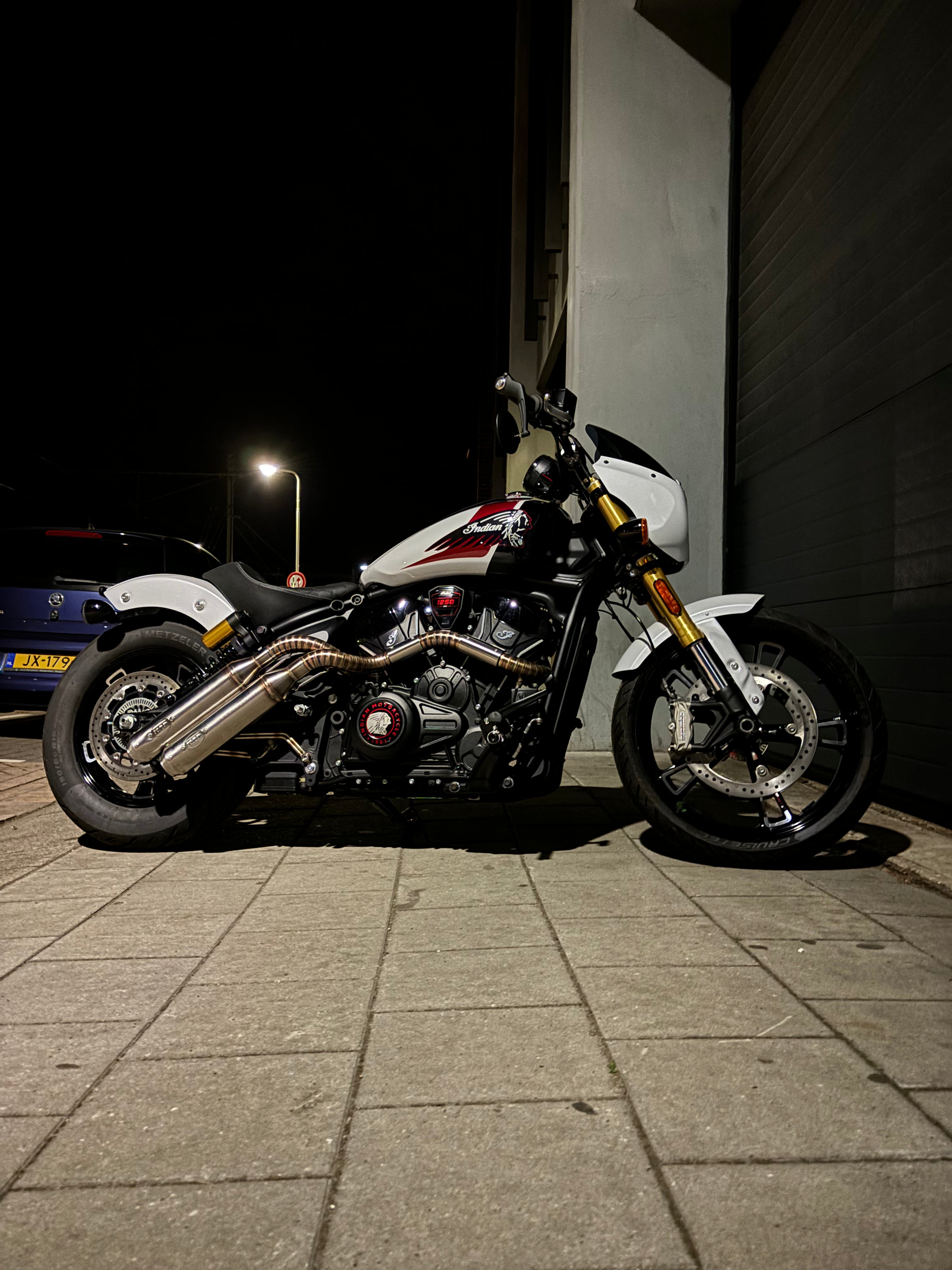 Indian Scout 1250 left-side view at night, MAD Exhausts down-swept twin silencers in full view