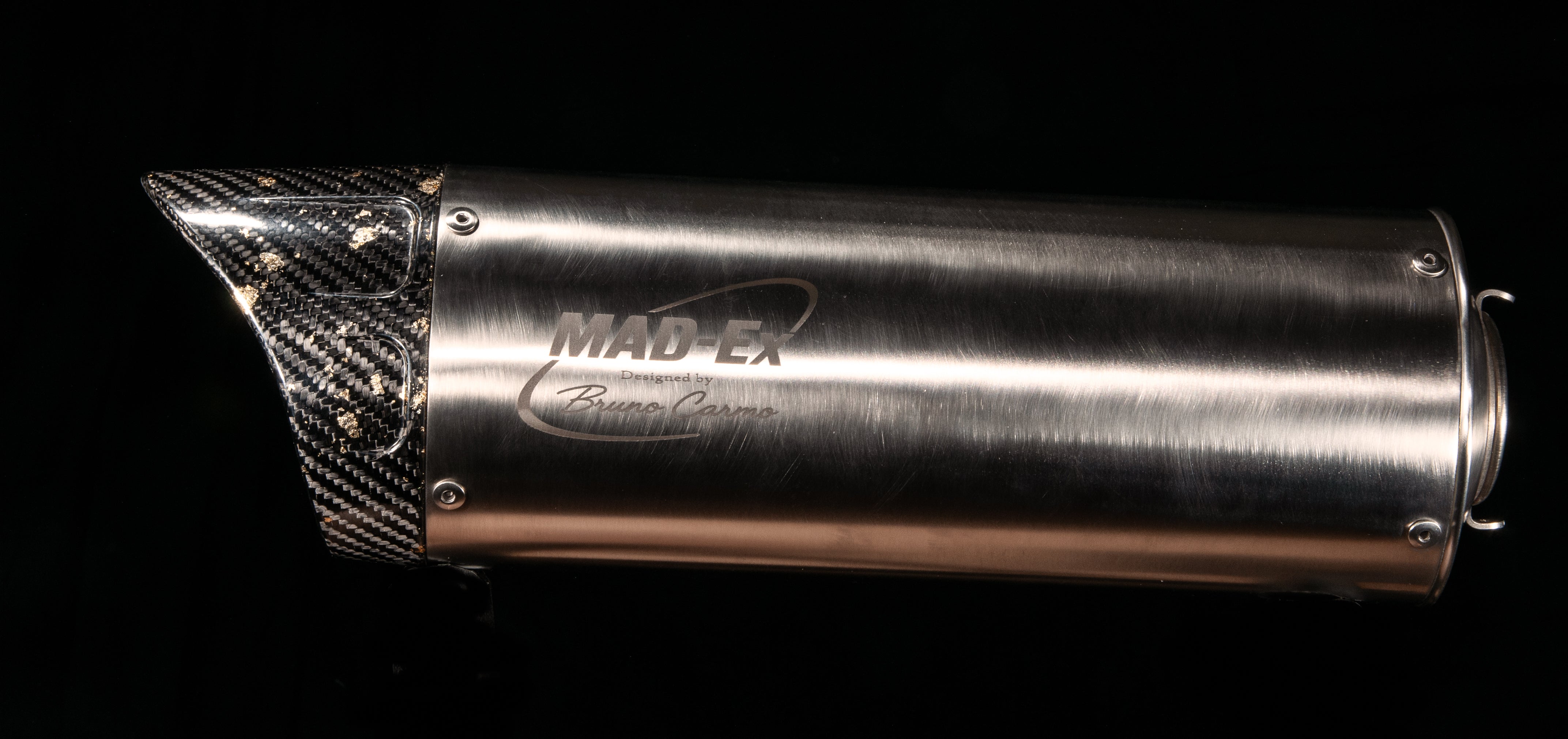 Side view of the MAD-EX R1 race muffler with carbon end cap, mounting springs and support bracket, studio photo on black