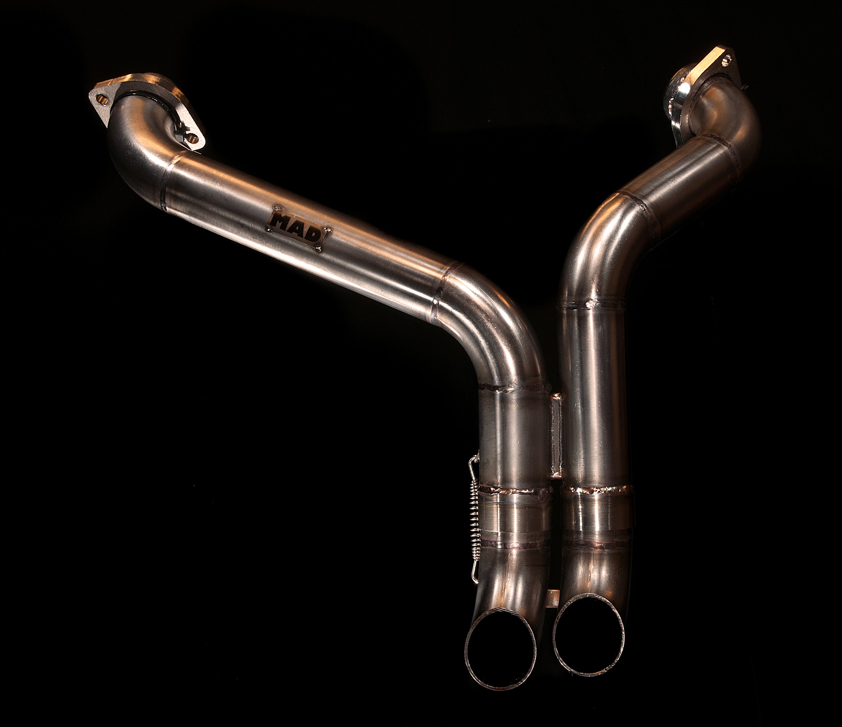 MAD Exhausts Harley-Davidson Sportster Shorty 2-into-2 short exhaust system with twin downward outlets and MAD logo, studio photo on black