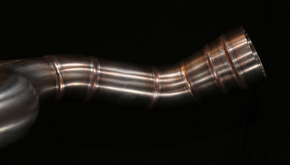 Close-up of a hand-TIG-welded bend on the MAD Exhausts BMW R nineT stainless steel header pipe