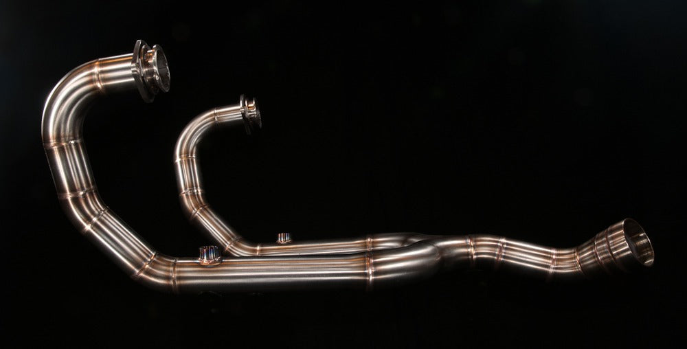 MAD Exhausts BMW R nineT 2-in-1 stainless steel exhaust system, full studio photo on black background showing both header pipes and collector