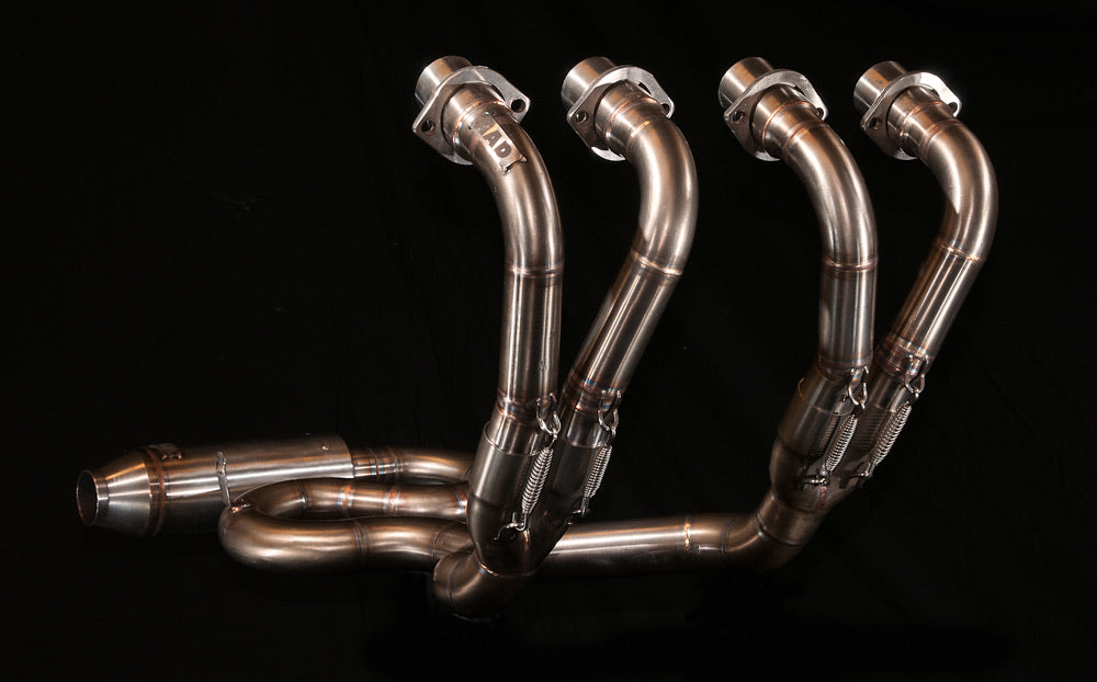 Four MAD Exhausts stainless steel header pipes of the Honda CB750 Cobra system merging 4-into-2-into-1, studio photo on black