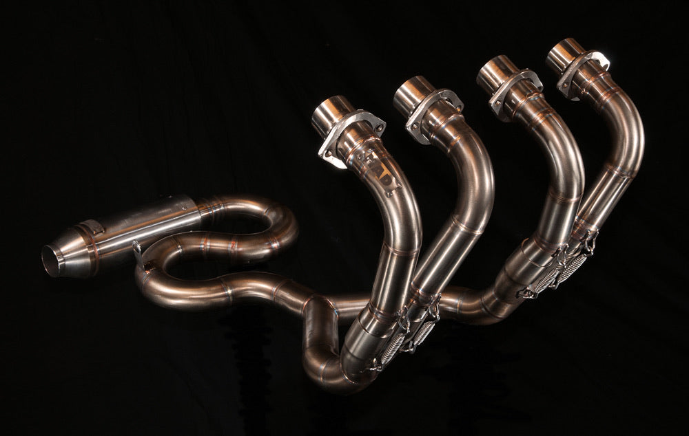 MAD Exhausts Honda CB750 "the Cobra" 4-in-2-in-1 stainless steel exhaust system, studio photo on black showing the snake-shaped routing and four flanges